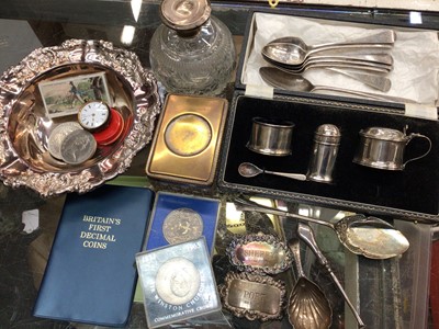 Lot 771 - Silver cruet set in case, silver teaspoons, silver caddy spoon, two silver spirit labels, silver topped glass scent bottle and sundries