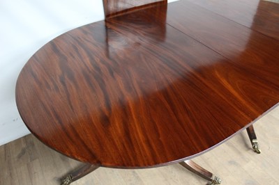 Lot 89 - Regency style mahogany twin pillar dining table
