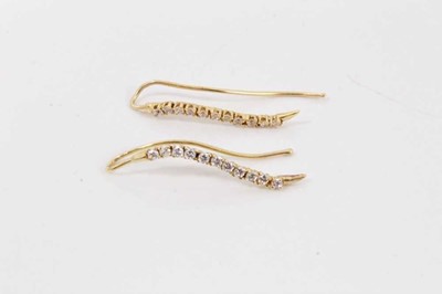 Lot 82 - Pair of gold (585) earrings, each with a serpentine line of eleven synthetic white stones