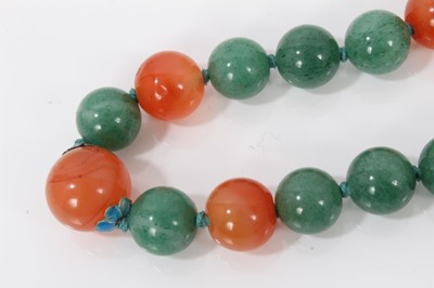 Lot 84 - Chinese green jade/hard stone and carnelian polished bead necklace with silver gilt clasp, 70cm long