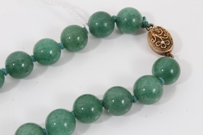 Lot 84 - Chinese green jade/hard stone and carnelian polished bead necklace with silver gilt clasp, 70cm long