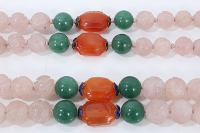 Lot 198 - Two Chinese carved pink hard stone bead necklaces