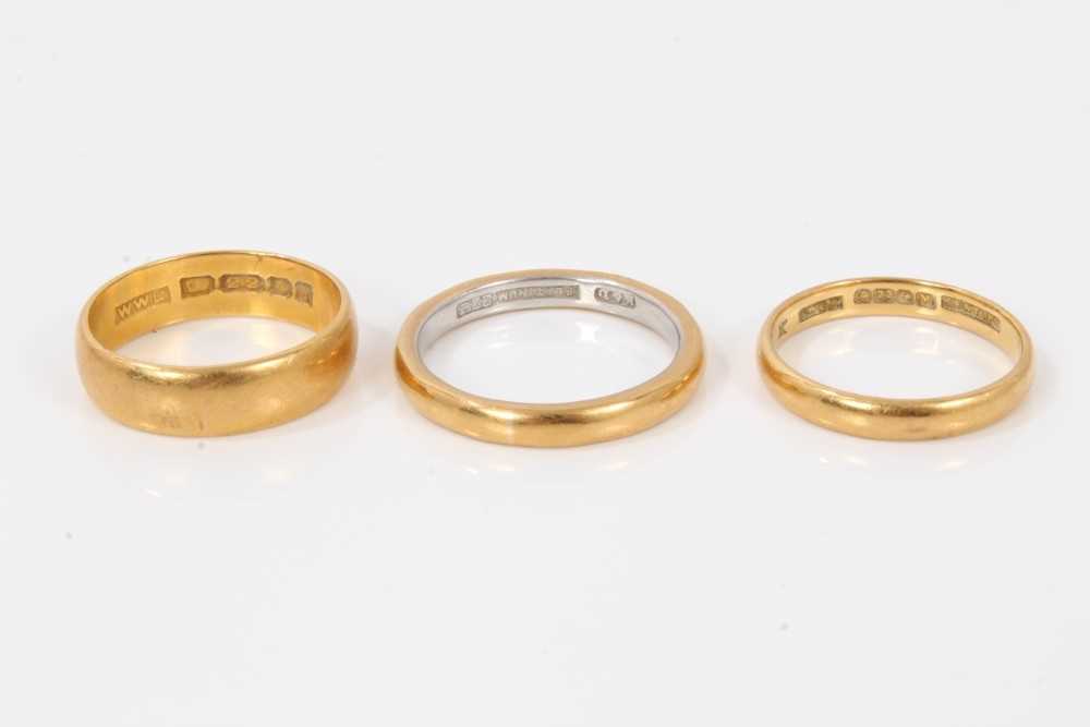 Lot 204 - Three 22ct gold wedding rings, one with platinum interior