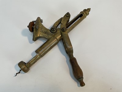 Lot 178 - Antique brass 'Shamrock' bar corkscrew with lever action and turned beech handle, stamped and numbered