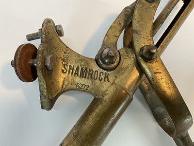 Lot 103 - Antique brass 'Shamrock' bar corkscrew with lever action and turned beech handle, stamped and numbered