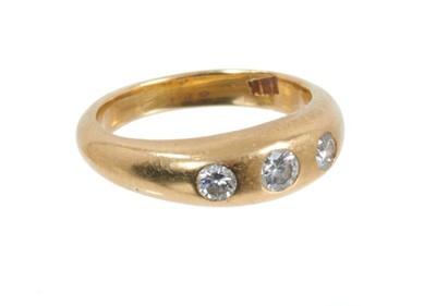 Lot 424 - Diamond three stone ring in 18ct gold gypsy setting