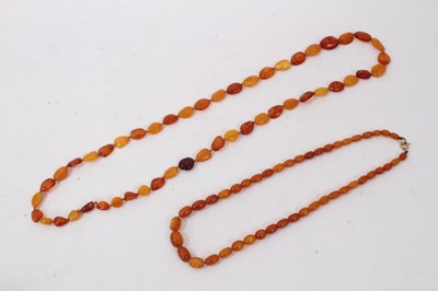 Lot 298 - Amber necklace with a string of graduated polished oval amber beads and one other amber bead necklace