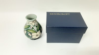 Lot 1223 - Moorcroft pottery vase decorated in the Clematis pattern, signed and dated 28.5.93, 13.5cm high, boxed