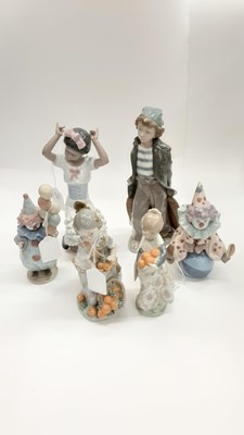 Lot 1359 - Six Lladro porcelain figures including including two clowns and two girls with fruit