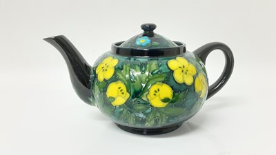 Lot 1231 - Moorcroft pottery teapot decorated in the Buttercup pattern, designed by Sally Tuffin, 12,5cm high