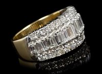 Lot 652 - Diamond dress ring, the wide band with a row...