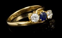 Lot 653 - Sapphire and diamond three stone crossover...