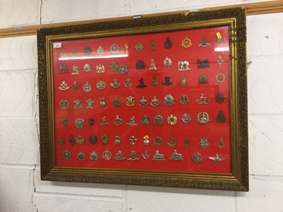 Lot 738 - Large glazed frame mounted with approximately 84 British military cap badges (originals and reproductions noted), 86 x 67cm overall.