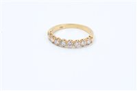 Lot 654 - Diamond eternity ring, the half hoop with a...