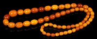 Lot 656 - Old amber bead necklace with a string of...