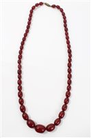 Lot 657 - Vintage simulated cherry amber necklace with...