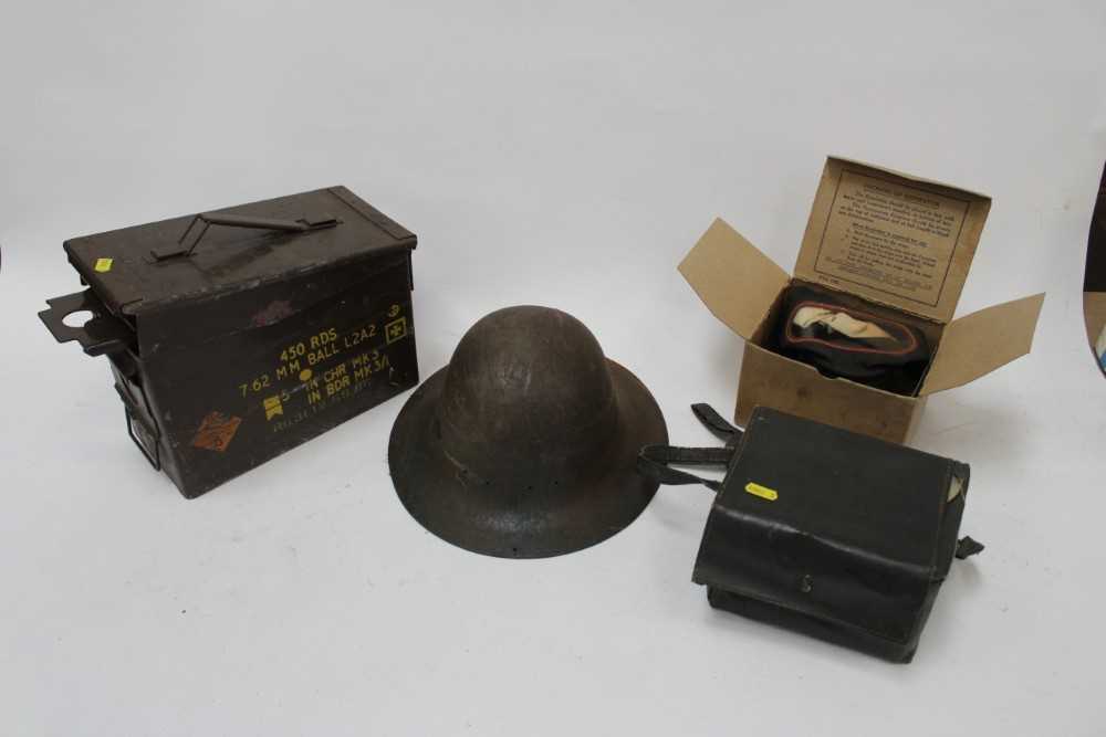 Lot 877 - Second World War tin helmet, together with two gas masks in box and a metal ammunition case (1 box)