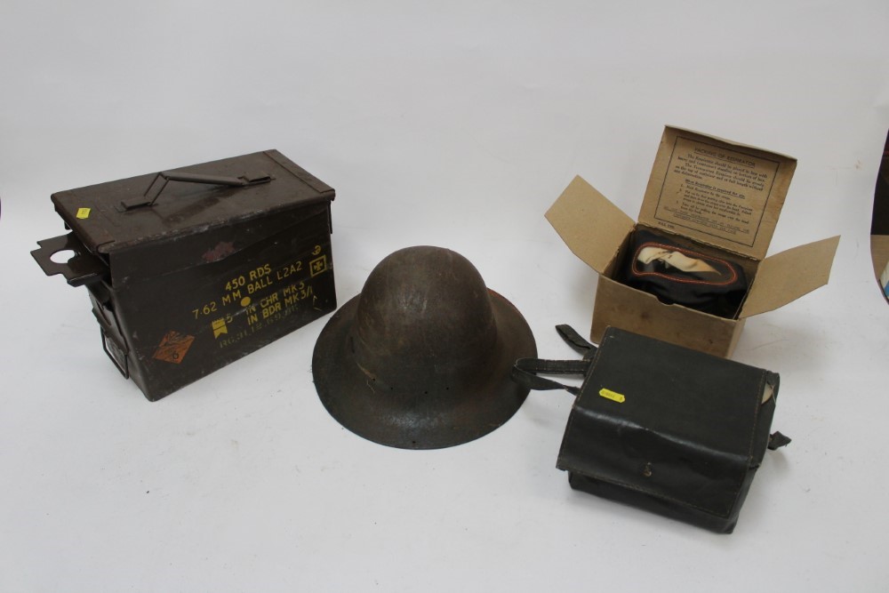 Lot 877 Second World War tin helmet, together with