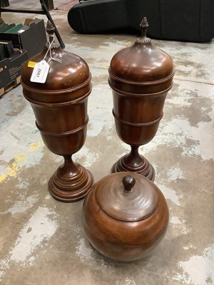 Lot 2687 - Pair of turned wood urns and covers and another (3)