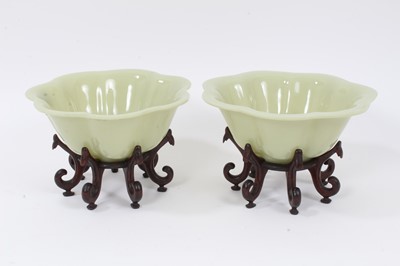 Lot 182 - Pair of Chinese Peking glass lobed green bowls on wooden stands