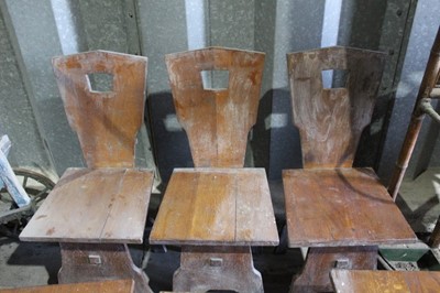 Lot 26 - Six Continental oak kitchen chairs with shaped supports and solid seats and backs