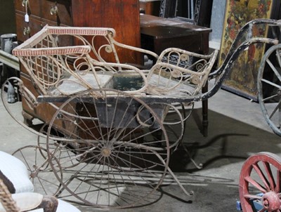 Lot 42 - Late Victorian childs perambulator with wicker framed seating, iron wheels and two other childs wooden garden wagons (3)