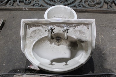 Lot 143 - 1920s ceramic bathroom sink with with moulded shells, original taps and cast iron brackets 65 cm wide, 50 cm deep and two ceramic hand basins (3)