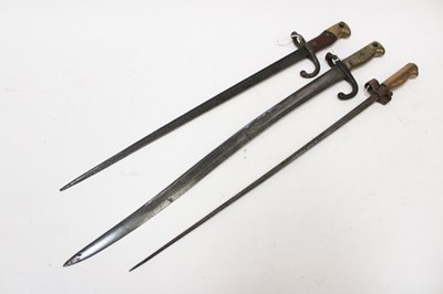 Lot 910 - First World War French 1886 pattern Lebel bayonet, together with a French 1874 pattern Gras bayonet and a French 1866 pattern Chassepot bayonet, all lacking scabbards (3)