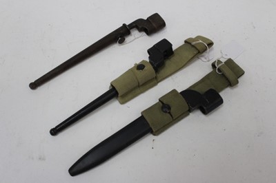 Lot 916 - Second World War British No.4 MK II spike bayonet in scabbard with canvas webbing frog, together with another spike bayonet and a knife bayonet (3)