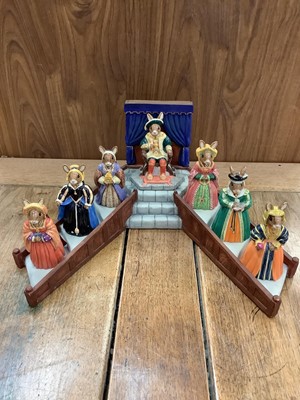 Lot 1293 - Royal Doulton Bunnykins Tudor Collection comprising Henry VIII and his six wives, complete with stand, all boxed with certificates