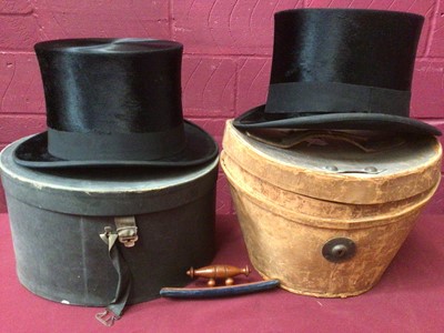 Lot 2241 - Two Black Top Hats one by Hyam & C0 Brimingham in leather top hat box ,the other by Fritz Luder, Berlin in hat box.  plus a turned wood and velvet top hat brush.