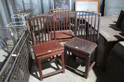 Lot 172 - Three 19th century Chinese fruitwood chairs with rail backs and solid seats