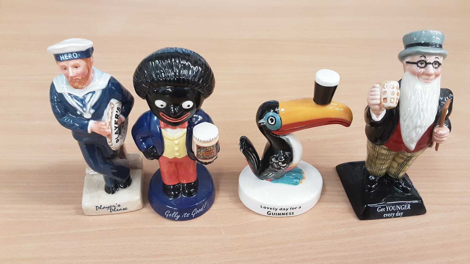 Lot 1304 - Four Royal Doulton limited edition 20th Century Advertising Classics - Player's Hero, Father William, Guinness Toucan and Golly, all boxed with certificates