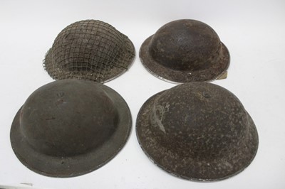 Lot 792 - Second World War British Military steel helmet stamped - 1940, 791, C.E.C. & Co Ltd, with painted RAF badge to front, together with helmet net and two other similar steel helmets (4)