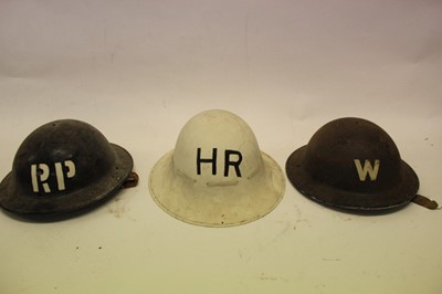 Lot 796 - Second World War British Military steel helmet with painted RP (Repair Party) to front and dated 1940 under brim, together with another with painted W (Warden) to front and other with painted HR to...