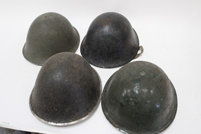 Lot 797 - Collection of four Second World War and later British Military MKIII and MKIV pattern steel helmets (4)