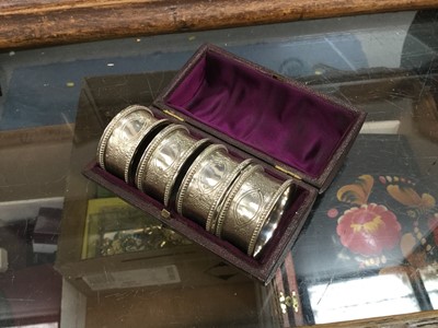 Lot 702 - Set of four Victorian silver napkin rings with engraved engine turned decoration and vacant cartouche in original fitted leather box (London 1876)