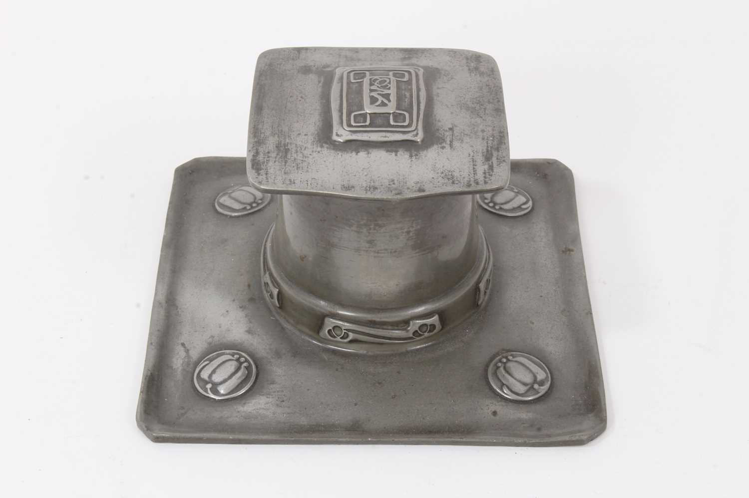 Lot 2676 - A Liberty Tudric Pewter inkwell designed by Archibald Knox, model no.0141, square section tray with tapering drum well and hinged square section cover, cast in low relief with foliate panels, with...