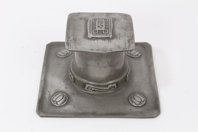 Lot 2676 - A Liberty Tudric Pewter inkwell designed by Archibald Knox, model no.0141, square section tray with tapering drum well and hinged square section cover, cast in low relief with foliate panels, with...