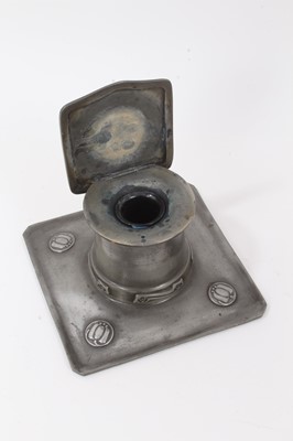 Lot 2676 - A Liberty Tudric Pewter inkwell designed by Archibald Knox, model no.0141, square section tray with tapering drum well and hinged square section cover, cast in low relief with foliate panels, with...