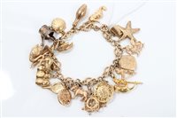 Lot 719 - Gold (9ct) charm bracelet with a collection of...