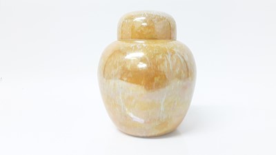 Lot 1338 - Ruskin pottery jar and cover, model number 1924, decorated in an orange lustre glaze, 17cm high