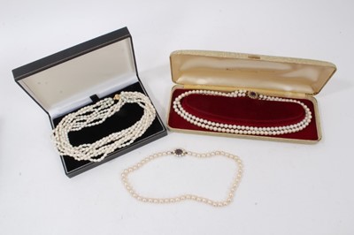 Lot 282 - Three pearl necklaces with gold clasps