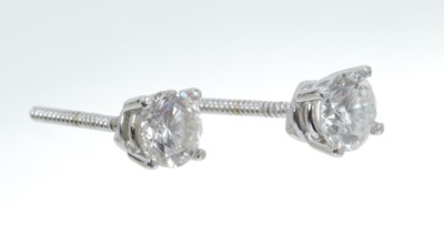 Lot 443 - Pair of diamond single stone earrings