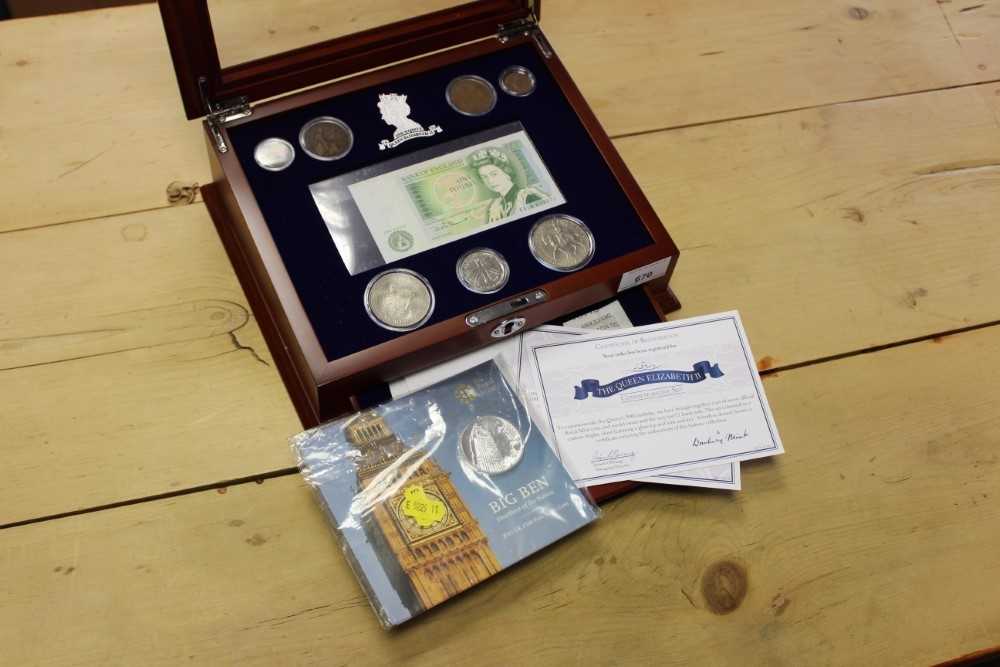 Lot 670 - G.B. Danbury Mint six coin base metal Elizabeth II '90th Birthday' commemorative set (with £1 banknote) and Royal Mint issued silver 'Big Ben' £100 coin 2015 in glass topped wood cabinet with Cert...