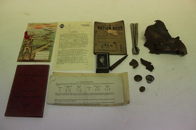 Lot 759 - Group of Second World War militaria to include Essex Regiment Wartime economy cap badge, another similar wound dressings and collection of shrapnel collected around the Colchester area (1 box)