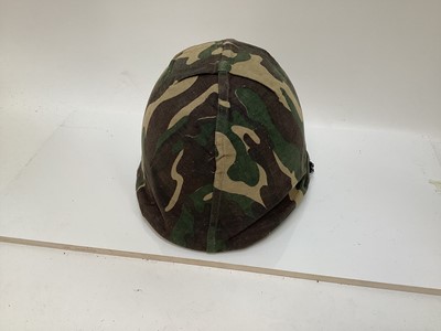 Lot 775 - American M1 steel helmet complete with liner, chinstrap and South Vietnamese camouflage cover, used by the Army of the Republic of Vietnam (ARVN) in support of US troops.