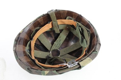 Lot 775 - American M1 steel helmet complete with liner, chinstrap and South Vietnamese camouflage cover, used by the Army of the Republic of Vietnam (ARVN) in support of US troops.