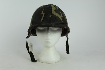 Lot 775 - American M1 steel helmet complete with liner, chinstrap and South Vietnamese camouflage cover, used by the Army of the Republic of Vietnam (ARVN) in support of US troops.