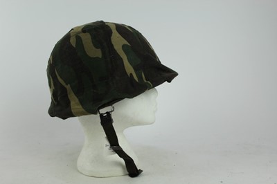 Lot 775 - American M1 steel helmet complete with liner, chinstrap and South Vietnamese camouflage cover, used by the Army of the Republic of Vietnam (ARVN) in support of US troops.